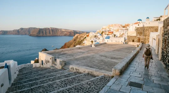 A serene historical landmark plaza at dawn with minimal visitors, illustrating the tranquil experience of strategic travel timing